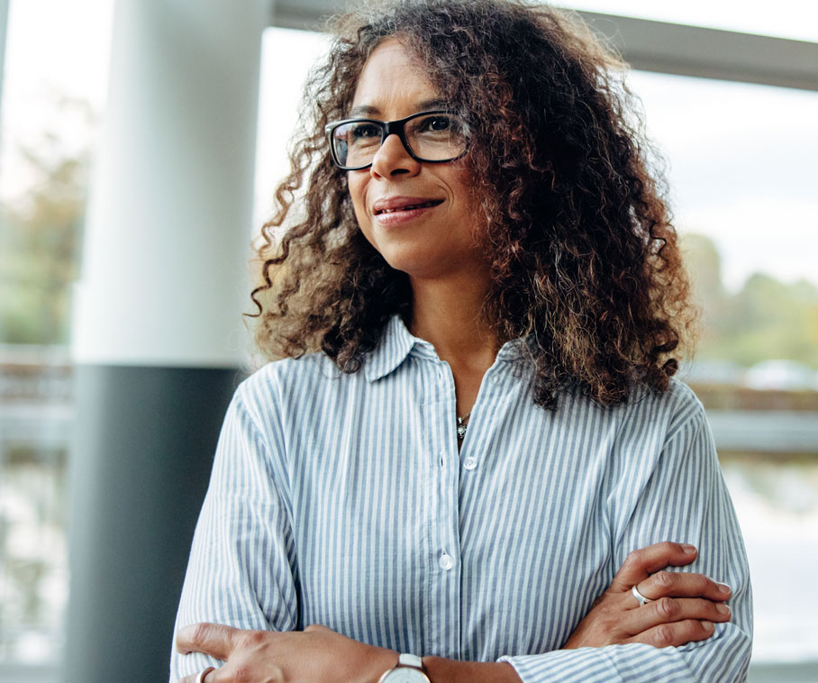 stock-photo-woman-entrepreneur-standing-beside-a-window-in-office-mature-woman-standing-in-office-with-arms-1935764008-2